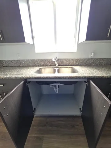 a kitchen with a sink and a window