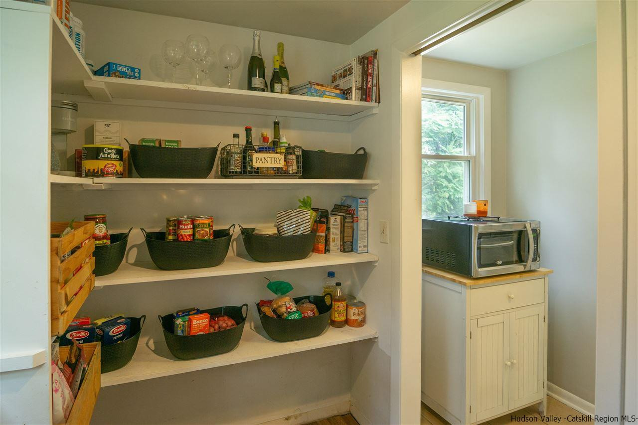 207 Marshall Road Salt Point, NY 12578 - Photo 12 of 22 a room with a wooden cabinet and shelf