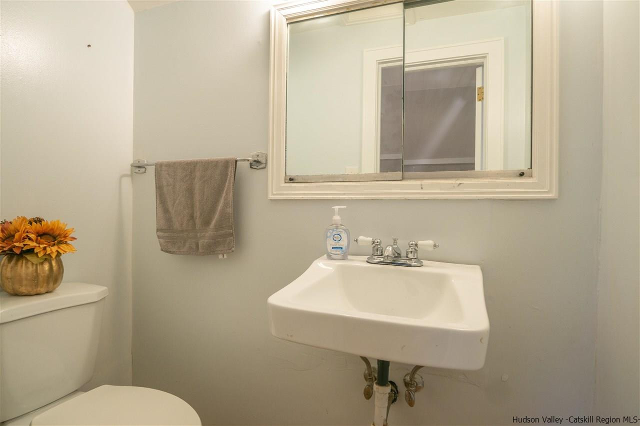 207 Marshall Road Salt Point, NY 12578 - Photo 19 of 22 a bathroom with a toilet sink and mirror