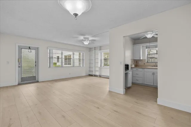 an empty room with a kitchen and a sink