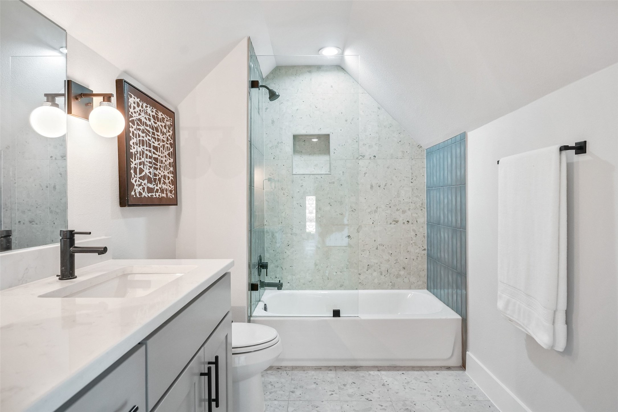 5109 Stone Gate Drive, Unit 2 Austin, TX 78721 - Photo 27 of 36 Contemporary bathroom featuring a single vanity with a white countertop and matte black fixtures