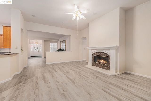 a view of empty room with wooden floor and window