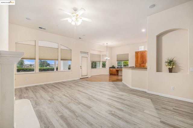 a view of kitchen with kitchen island and stainless steel appliances
