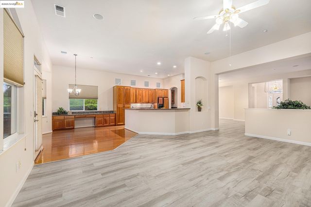 a view of a kitchen with a sink hardwood floor and a large mirror