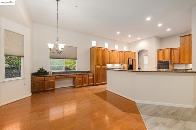 a kitchen with granite countertop a sink and a stove
