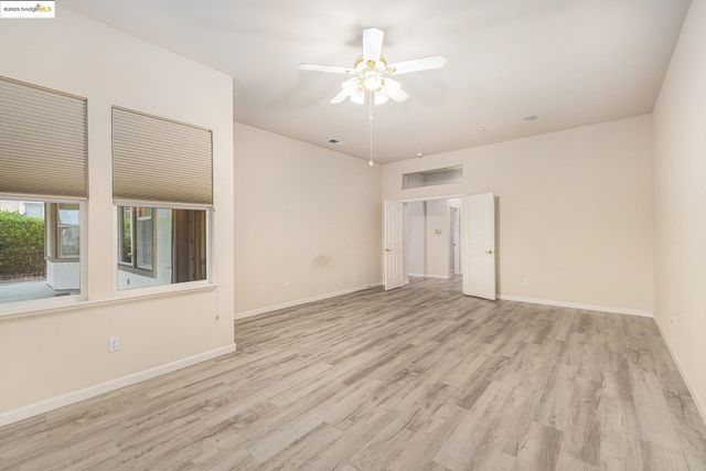 a spacious bathroom with a granite countertop sink and a bathtub