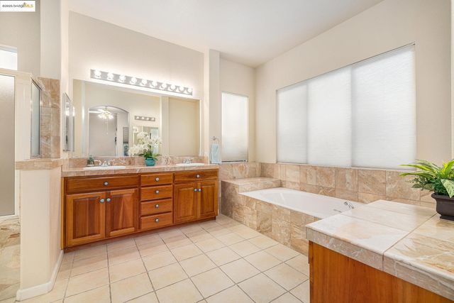 a spacious bathroom with a double vanity sink mirror and