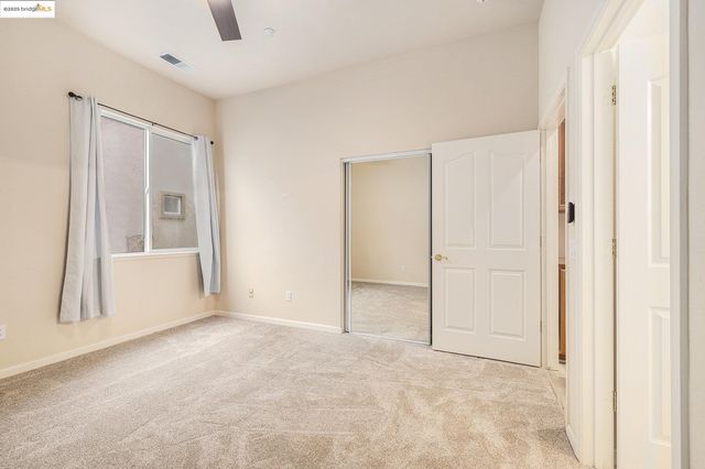 an empty room with a empty space and windows