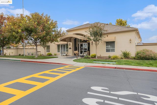 a view of a tennis court with trees in the background