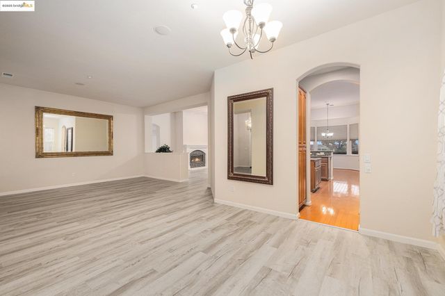 a view of a room with wooden floor and a window