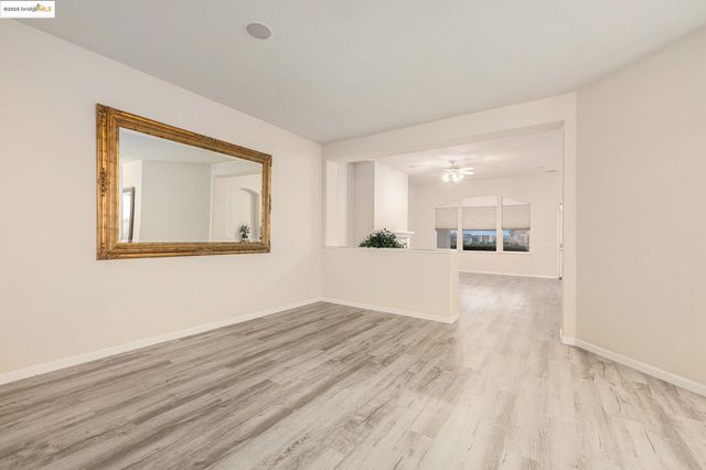 a view of a livingroom with a fireplace wooden floor and staircase