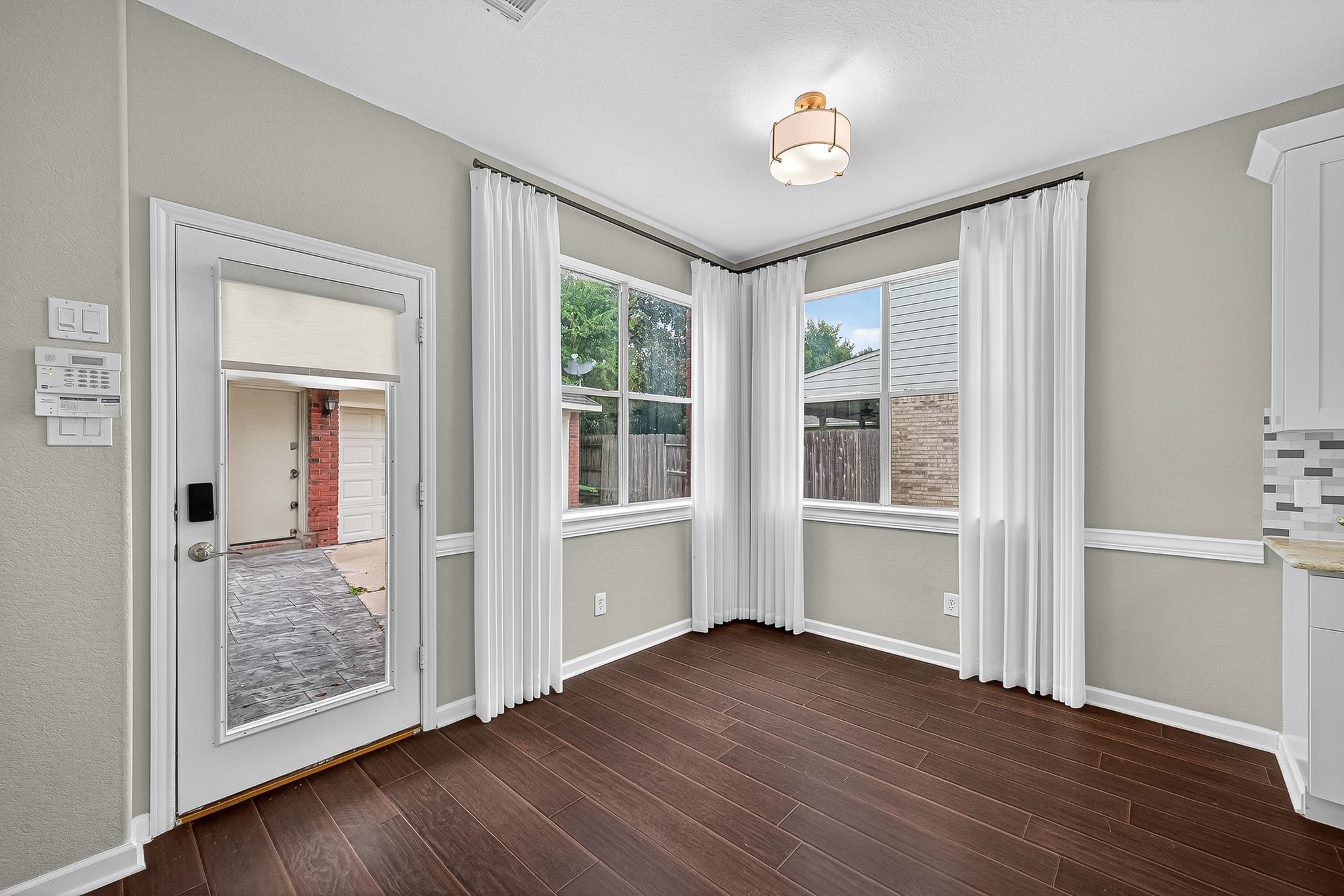 22406 Piper Terrace Lane Katy, TX 77450 - Photo 18 of 44 a view of an empty room with wooden floor and a window