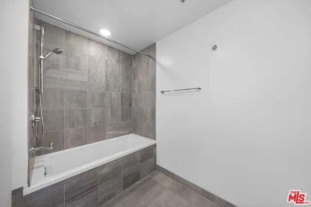 a bathroom with a granite countertop sink a toilet and a mirror