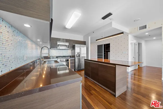 a kitchen with stainless steel appliances granite countertop a stove and a refrigerator