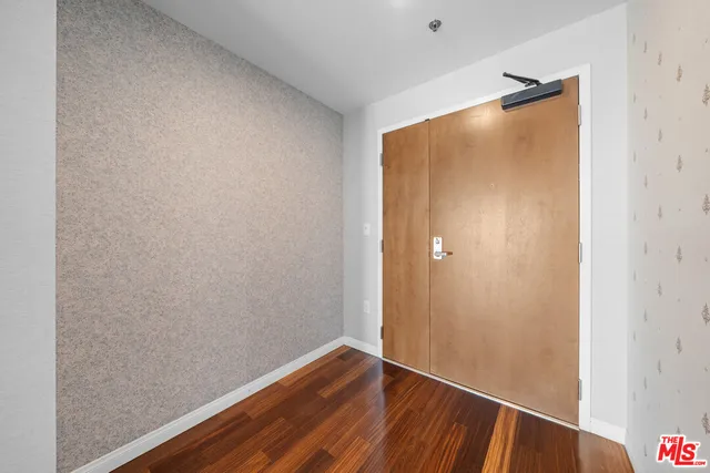 a view of walk in closet with wooden floor