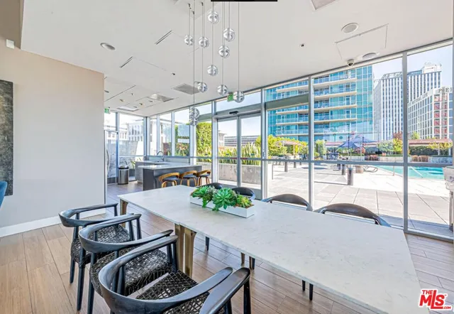 a large kitchen with a large window and stainless steel appliances