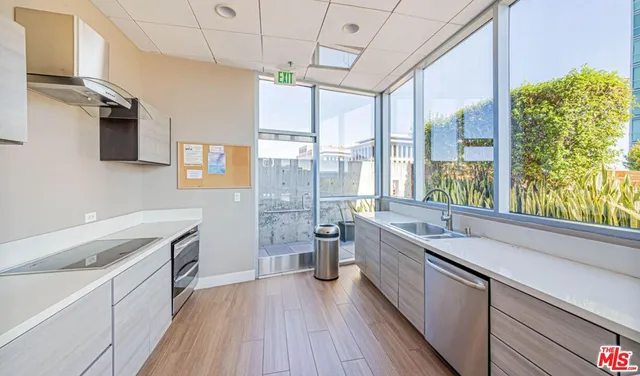 a kitchen with a sink appliances and cabinets