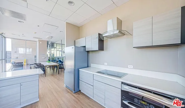 a balcony with chairs and a potted plant