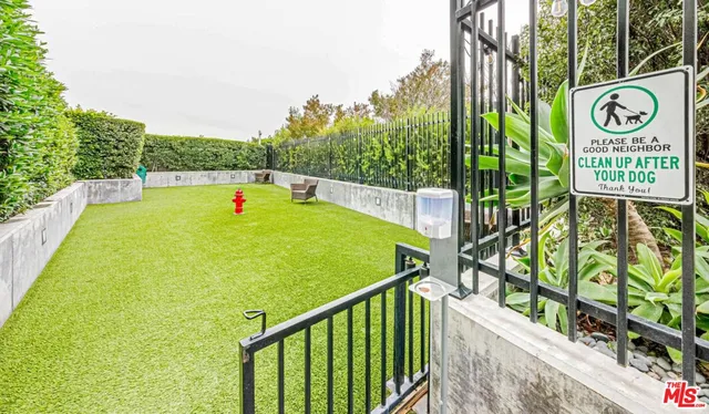 a living room with furniture and a book shelf