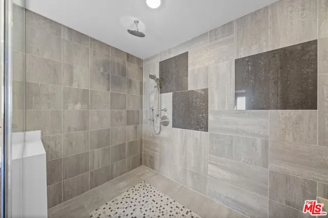 a bathroom with a granite countertop sink a toilet and shower