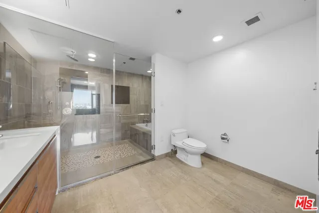 a spacious bathroom with a double vanity sink and mirror