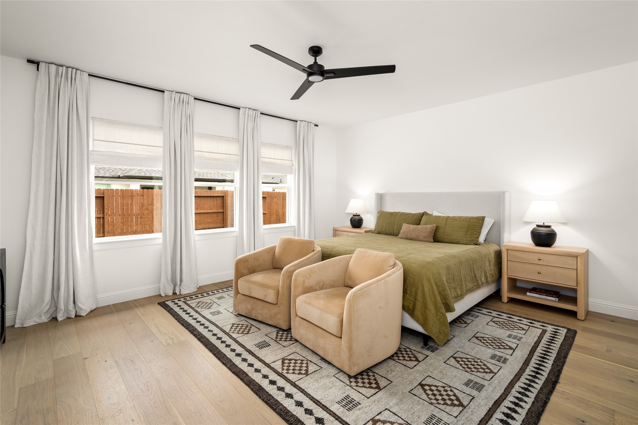 17461 Bayflower Conroe, TX 77385 - Photo 18 of 49 Spacious primary bedroom featuring large windows for natural light and ample space for a sitting area.