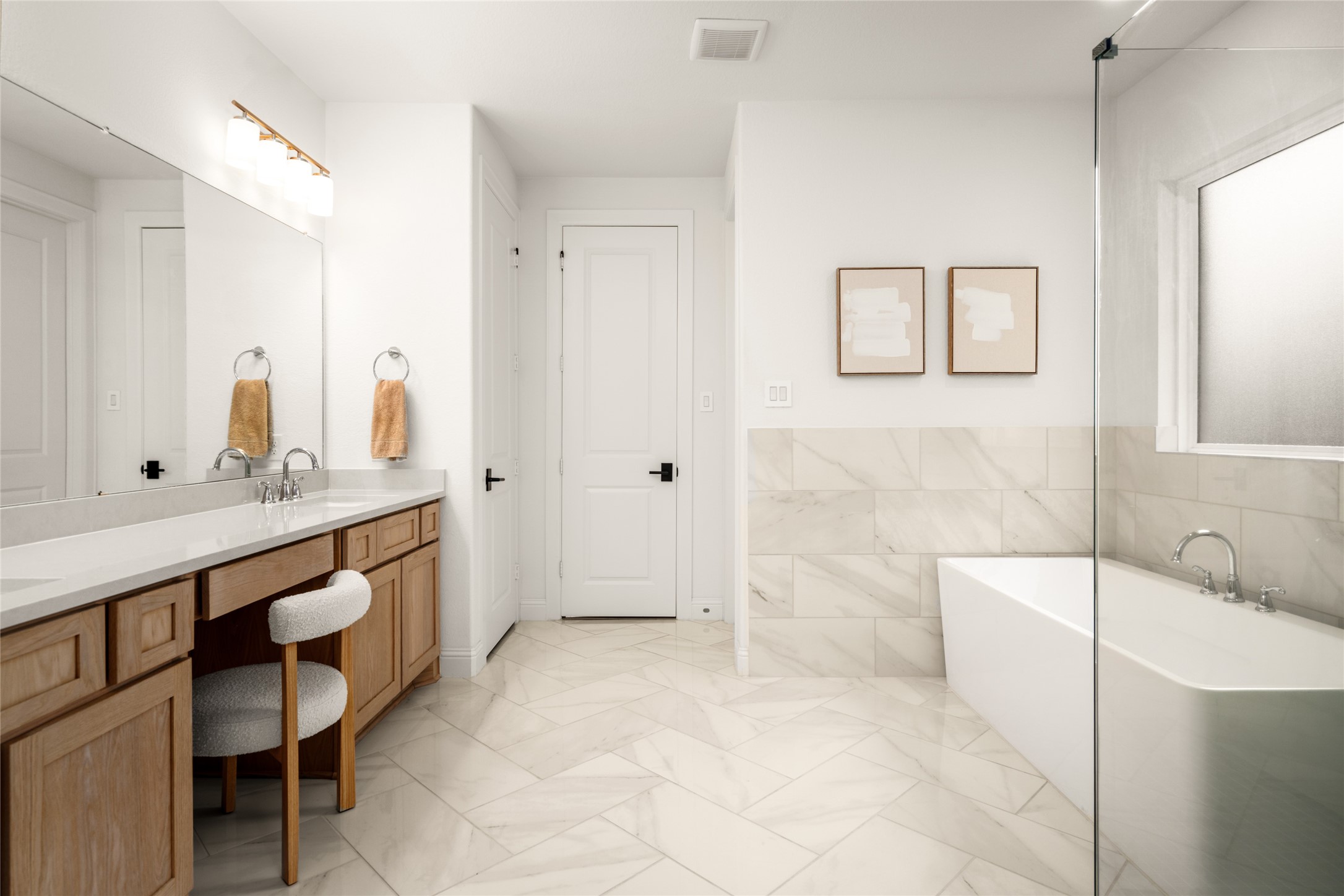 17461 Bayflower Conroe, TX 77385 - Photo 20 of 49 Spa-like primary bathroom with a frameless glass shower, freestanding soaking tub, and herringbone tile flooring.