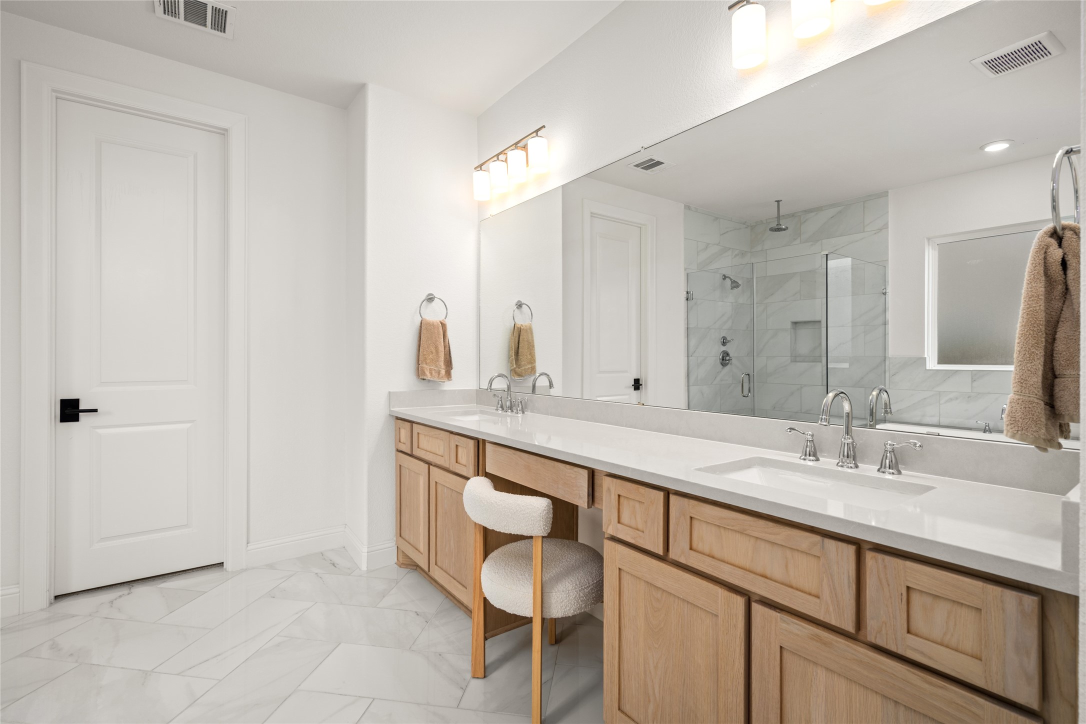 17461 Bayflower Conroe, TX 77385 - Photo 21 of 49 Expansive dual vanity with custom cabinetry, dual upgraded rectangular porcelain undermount sinks, and a dedicated makeup area.