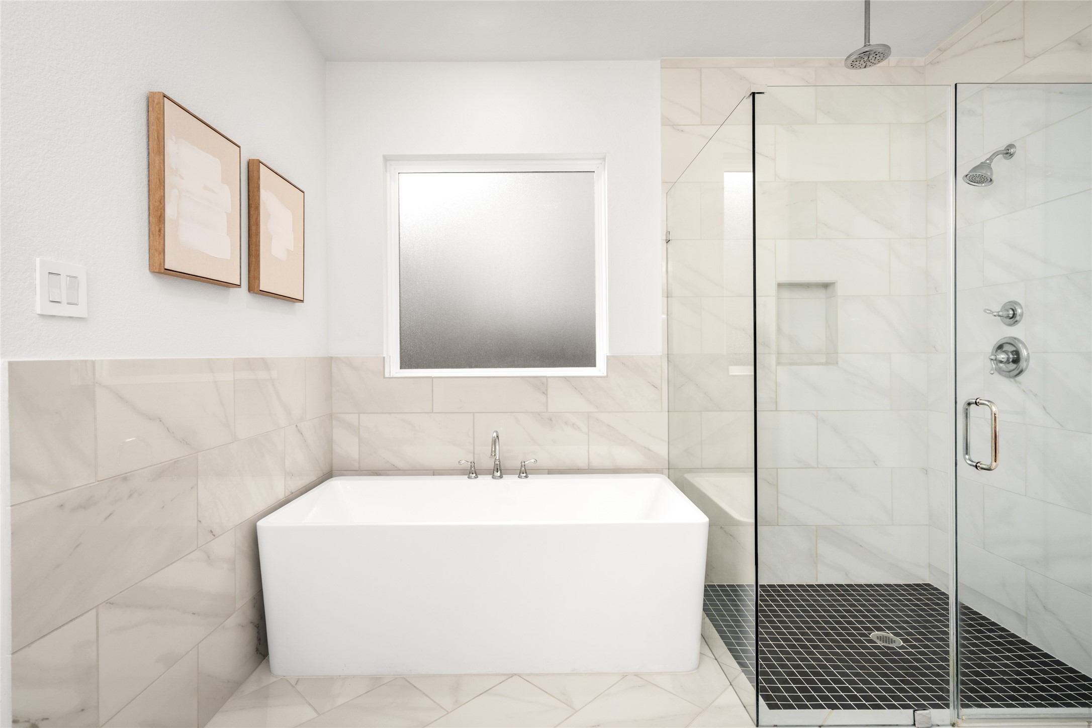 17461 Bayflower Conroe, TX 77385 - Photo 22 of 49 Frameless glass shower with a waterfall showerhead and a large soaking tub.