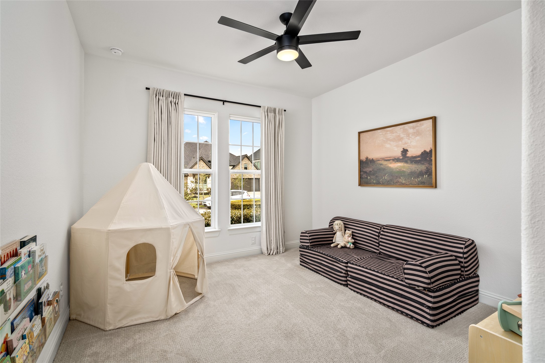 17461 Bayflower Conroe, TX 77385 - Photo 29 of 49 Front-facing 4th bedroom with abundant natural light and a modern ceiling fan.
