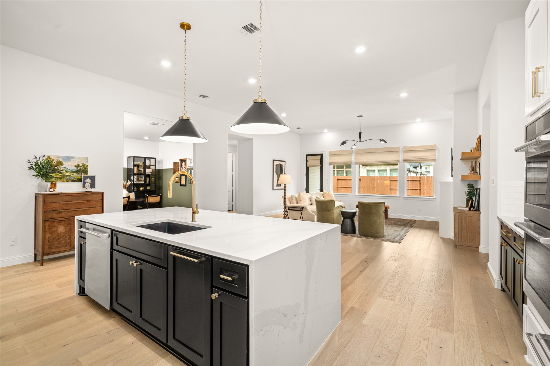 17461 Bayflower Conroe, TX 77385 - Photo 3 of 49 Upgraded level 7 quartz countertops with waterfall edges extending to the floor, and a Silgranit single-bowl kitchen sink.