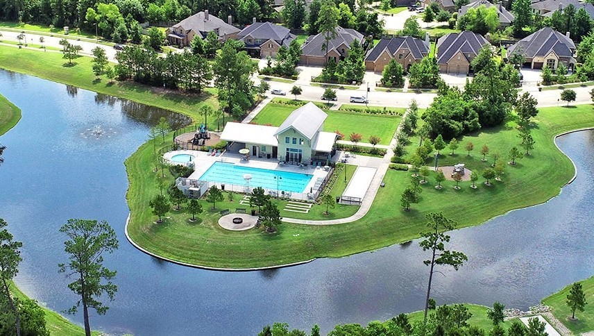 17461 Bayflower Conroe, TX 77385 - Photo 47 of 49 Resort style community pool and clubhouse overlooking the lake with landscaped grounds and gathering areas.