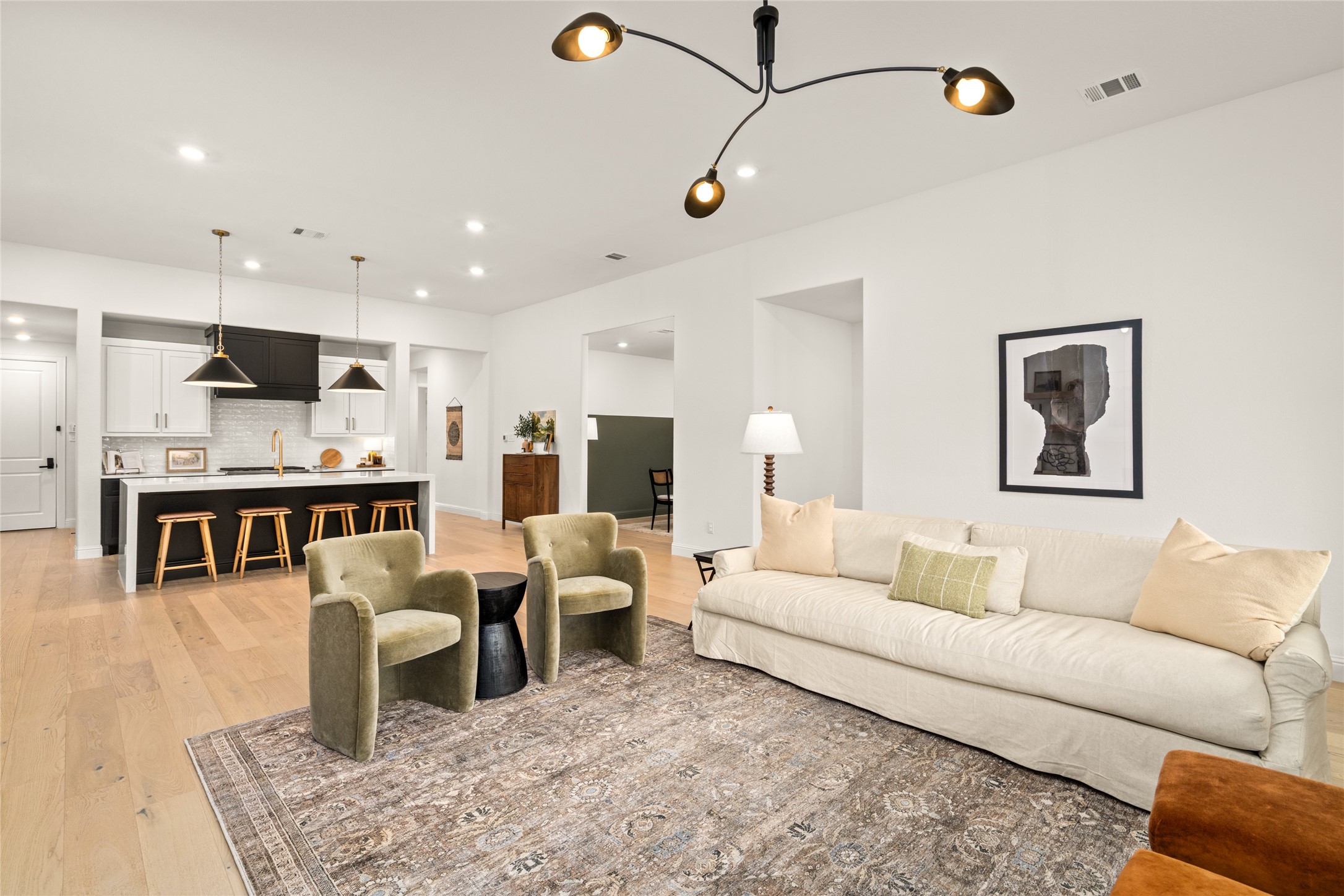 17461 Bayflower Conroe, TX 77385 - Photo 8 of 49 Spacious living area with an open concept layout enhanced by modern lighting and warm finishes throughout.