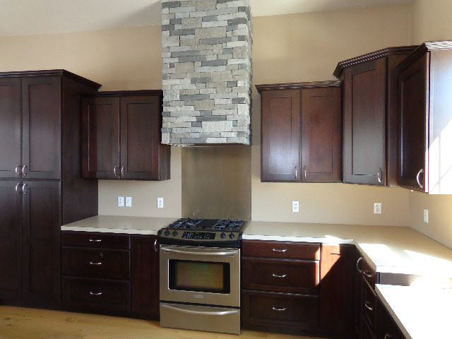 223 Natural Chimney Road Mount Solon, VA 22843 - Photo 6 of 18 a kitchen with wooden cabinets and a stove top oven