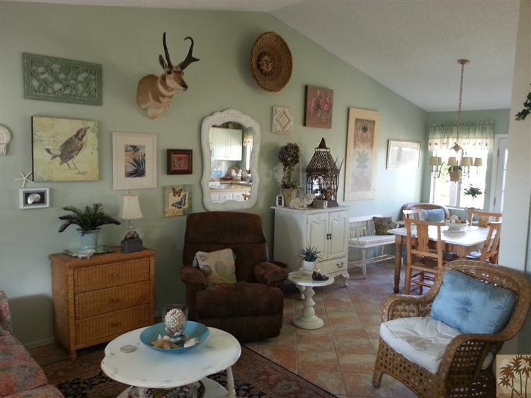 47800 Madison Street, Unit 99 Indio, CA 92201 - Photo 1 of 13 a living room with furniture and a chandelier