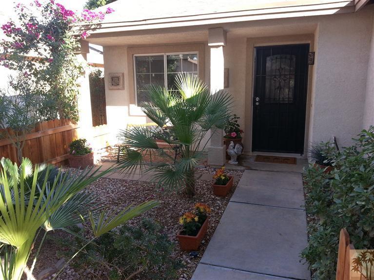 47800 Madison Street, Unit 99 Indio, CA 92201 - Photo 12 of 13 a backyard of a house with yard and outdoor seating