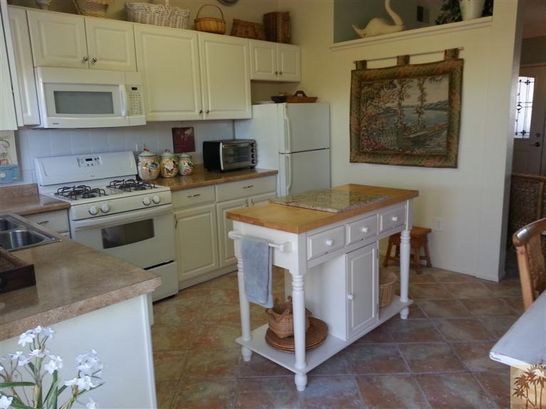 47800 Madison Street, Unit 99 Indio, CA 92201 - Photo 2 of 13 a kitchen with stainless steel appliances granite countertop a stove a sink and a microwave