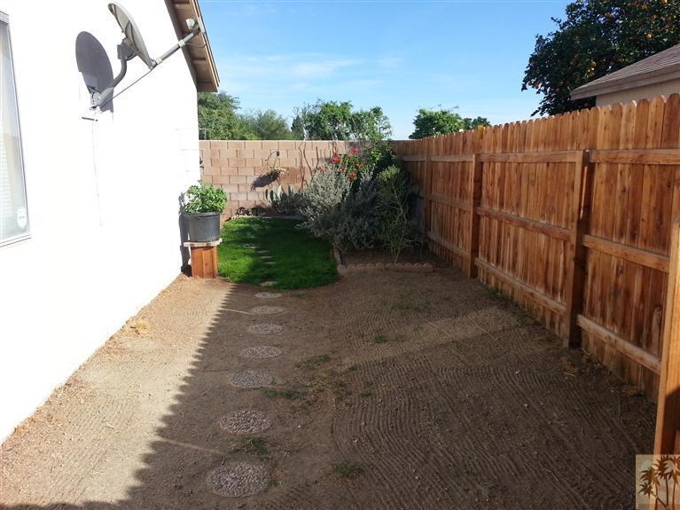 47800 Madison Street, Unit 99 Indio, CA 92201 - Photo 9 of 13 a view of a backyard with pathway