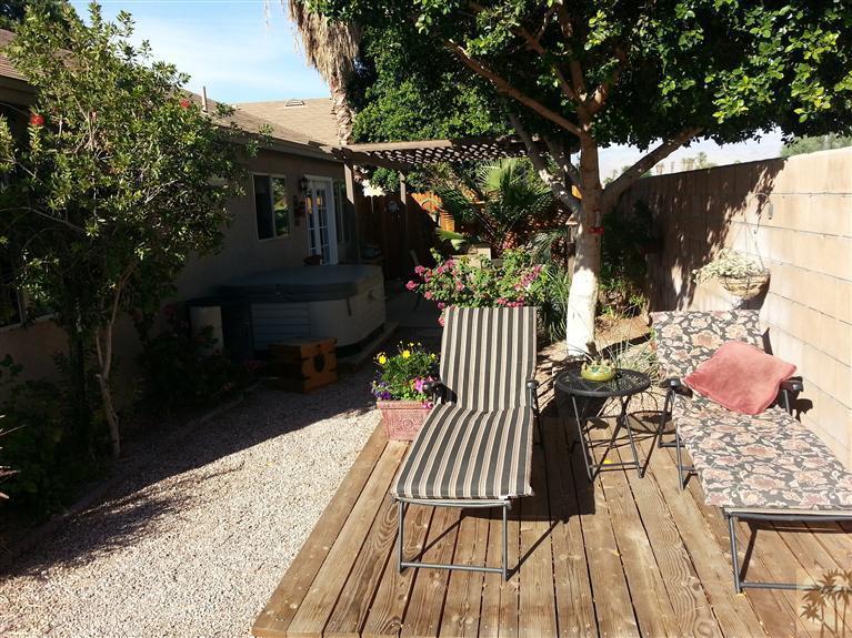47800 Madison Street, Unit 99 Indio, CA 92201 - Photo 10 of 13 a balcony with wooden floor table and chairs