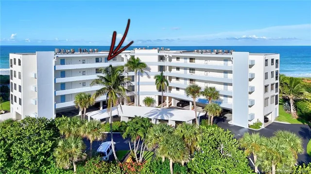 a view of swimming pool with outdoor seating and plants
