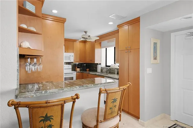 a dining room with furniture and a window