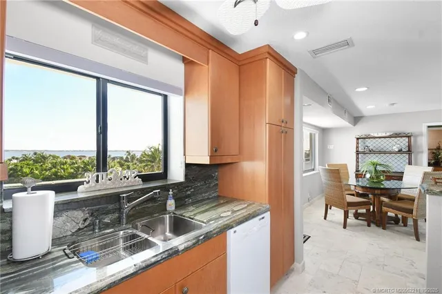 a kitchen with granite countertop sink and cabinets