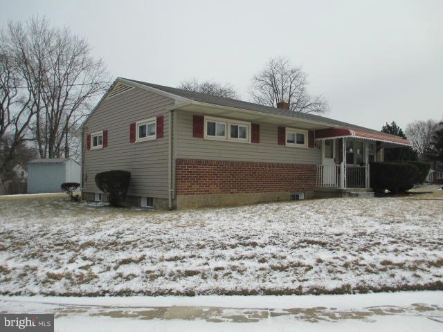 a house that has a tree in front of it