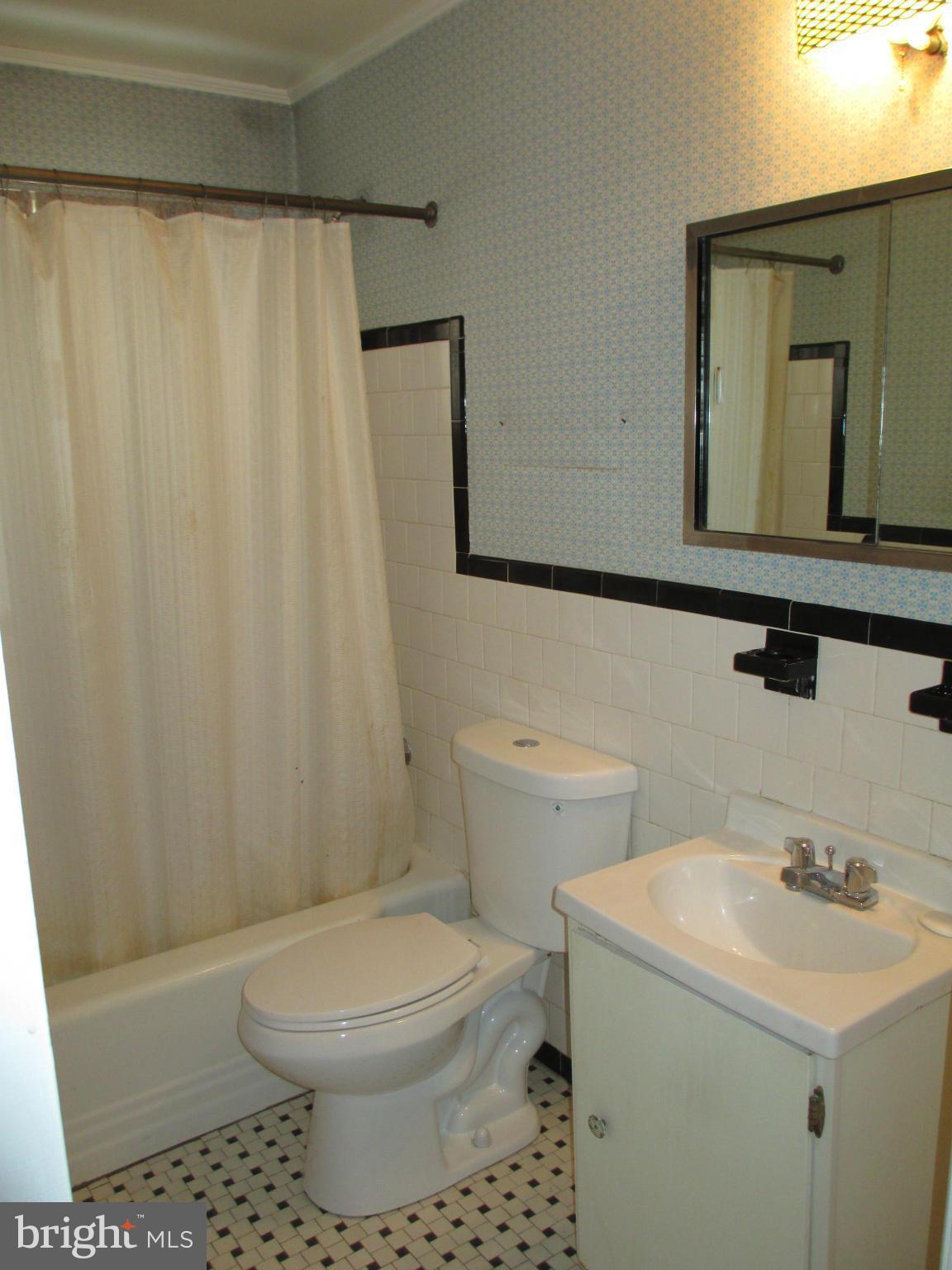 7426 Remoor Road Baltimore, MD 21207 - Photo 15 of 28 a bathroom with a toilet sink vanity and mirror