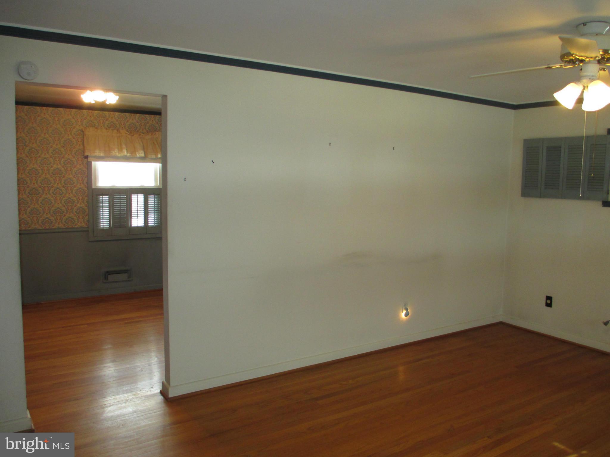 7426 Remoor Road Baltimore, MD 21207 - Photo 4 of 28 an empty room with wooden floor and windows