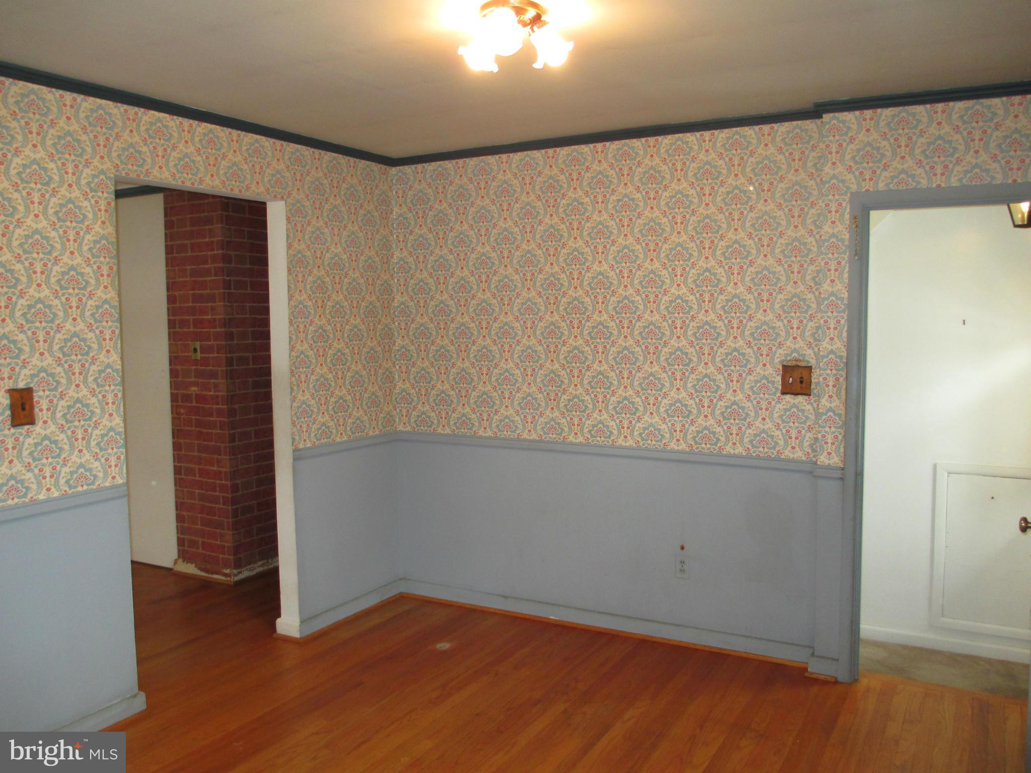 7426 Remoor Road Baltimore, MD 21207 - Photo 5 of 28 an empty room with wooden floor and closet
