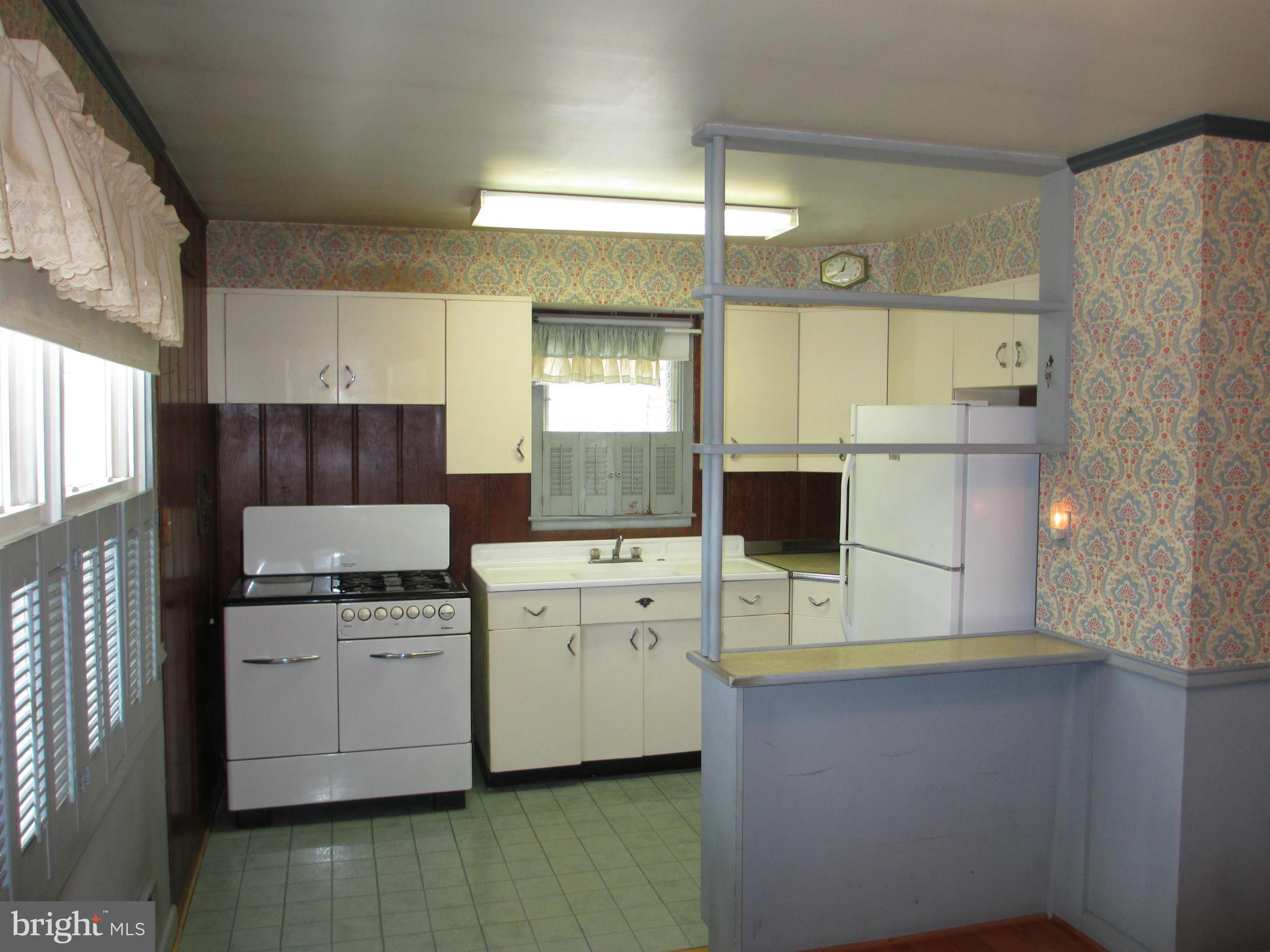 7426 Remoor Road Baltimore, MD 21207 - Photo 6 of 28 a kitchen with white cabinets and sink