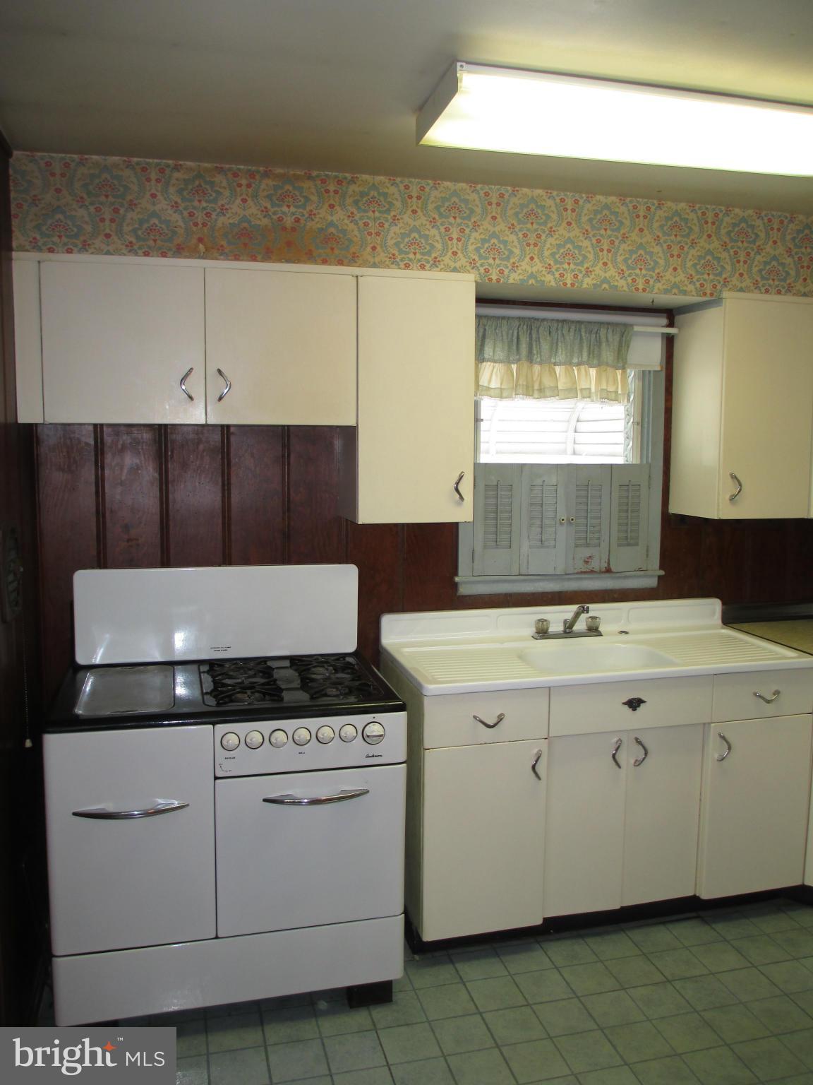 7426 Remoor Road Baltimore, MD 21207 - Photo 7 of 28 a stove top oven sitting inside of a kitchen