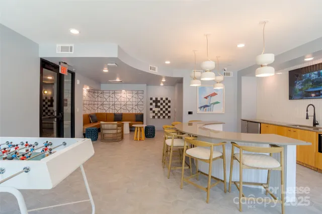 a kitchen with a dining table chairs sink and view kitchen