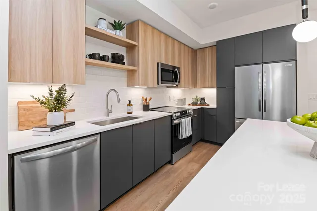 a kitchen with a sink a refrigerator and cabinets